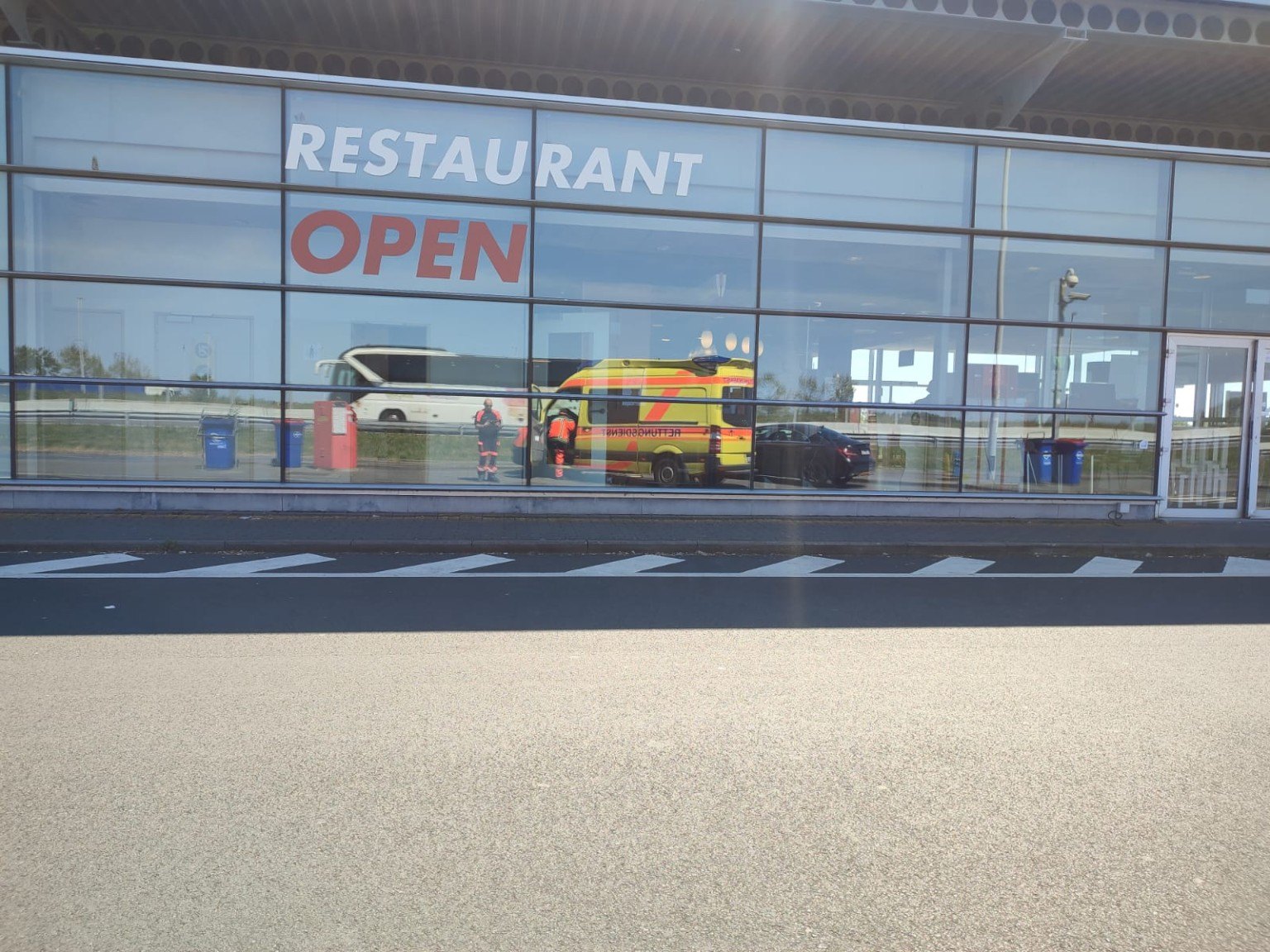 Ambulance reflected in building windows